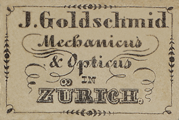 Eine alte Visitenkarte mit der Aufschrift "J. Goldschmidt Mechanicus & Optics in Zurich" aus dem frühen 20. Jahrhundert.